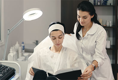 cosmetologist showing her patient innovations cosmetology