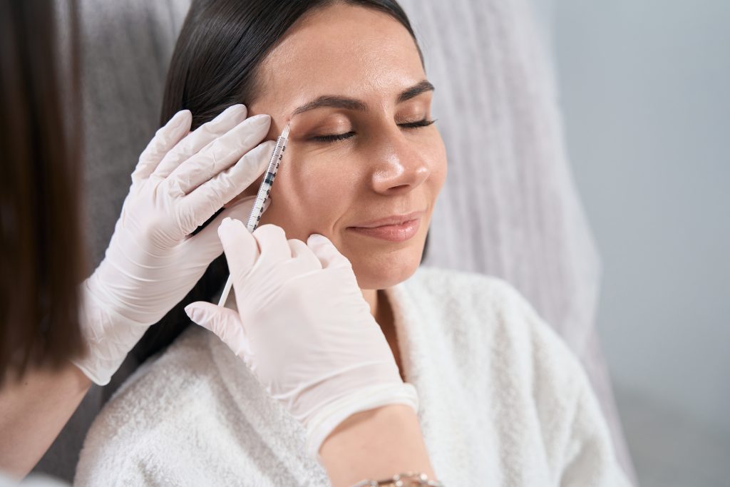 Beautiful lady on injection procedure, skin nutrition