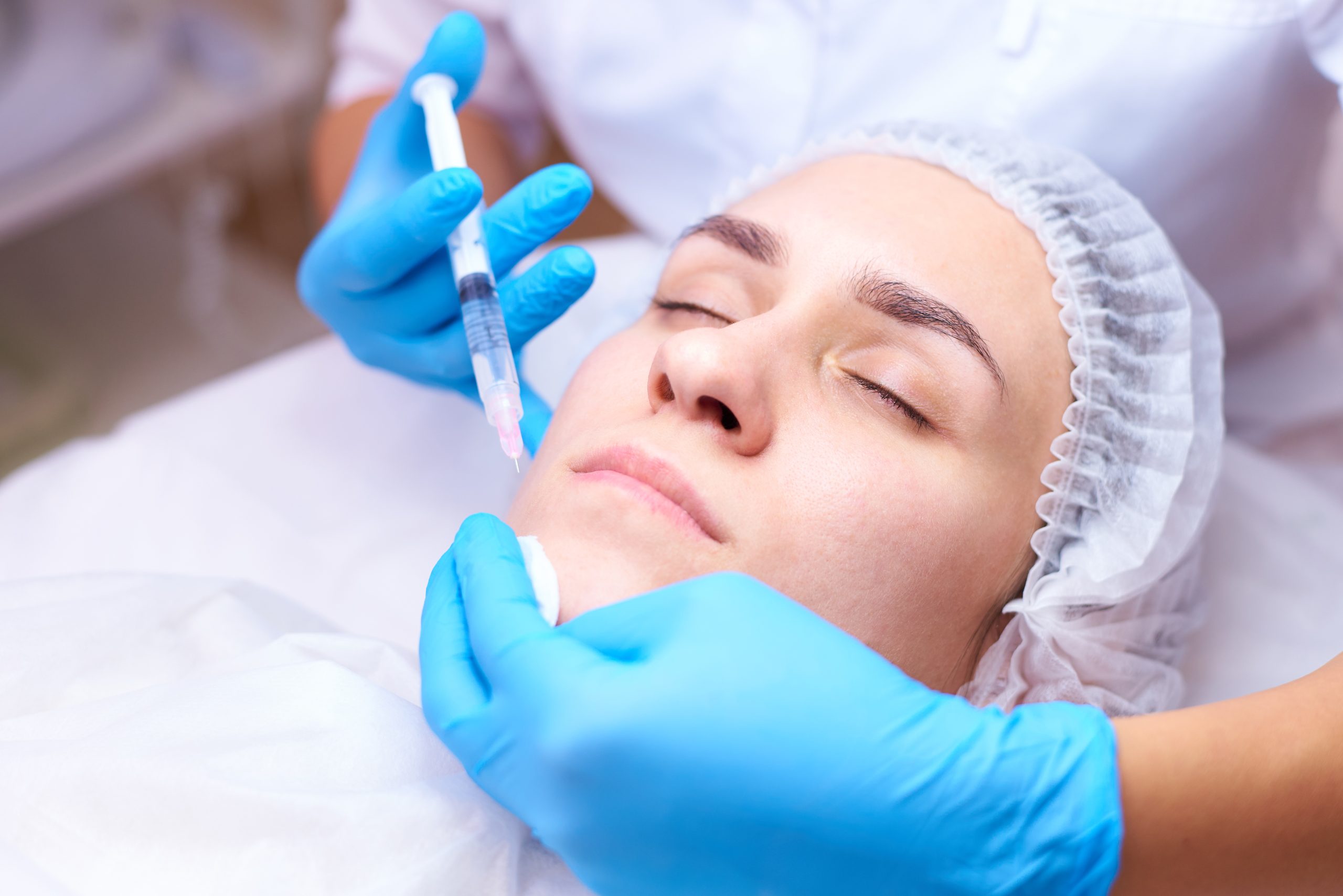 Young woman on rejuvenation procedure in a cosmetology clinic.