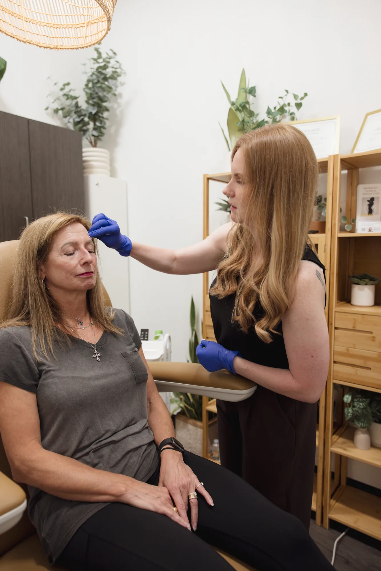 Provider marking a patient's brow before an aesthetic treatment