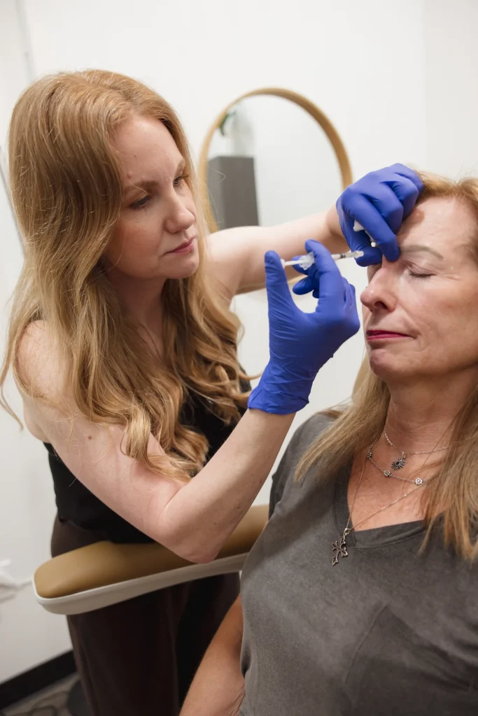 Close-up of a provider administering a treatment near a patient's forehead