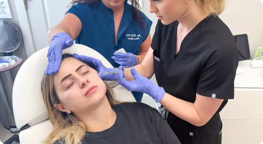 Instructor supervising a live-patient injection